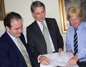 Philip Hammond (centre) looking at a map of the route with local MPs