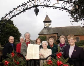 HARLASTON ARCHIVES 5 The Venerable Chris Liley, Thea Randall (county archivist), Philip Wood (church warden), Alison Birch, Mary Tiso, Stella Harris, Chris Strophair and Reverend Denise Burgess with the documents