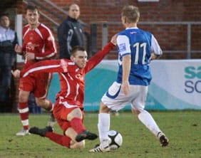 Richard Davies slides in to win the ball. Pic: Dave Birt