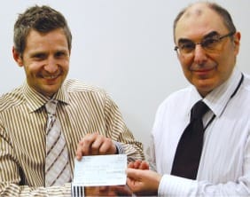 Heritage Stairlifts Spencer Kendall handing over a cheque for £3,000 to Barry Rosenburg from the Royal British Legion
