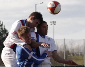 Ben Jevons is crowded out by two Whitby defenders. Pic: Dave Birt