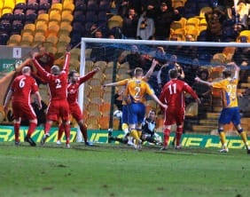Louis Briscoe nets in controversial fashion to make it 2-1 to Mansfield Town. Pic: Dave Birt