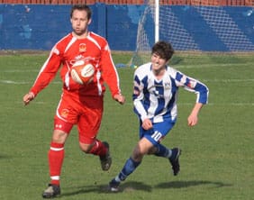 Chasetown's Chris Slater is challenged by Jack Watts. Pic: Dave Birt