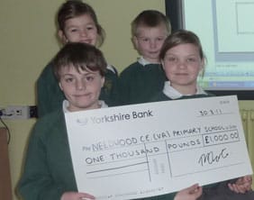 Caleb Irons, Ami Rock, Harriet Harte and Harry Neeson with the cheque