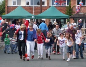 Redlock Field residents in a three-legged race