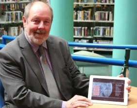 Cllr Pat Corfield with an e-book Cllr Pat Corfield with an e-book