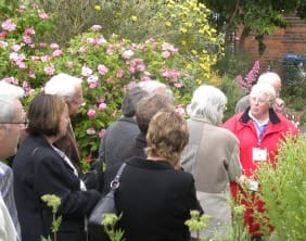 Tour guide Susan Baird leads the group through the herb garden at Erasmus Darwin House