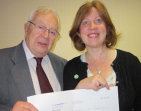 Cllr Doug Constable presents a cheque to a representative of Macmillan Cancer Support