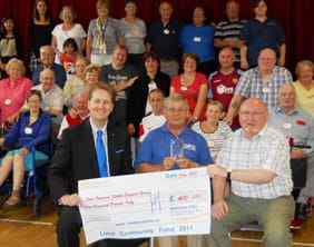Cllr Matthew Ellis hands over a cheque to the Step Forward support group