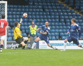 The FC United keeper is deceived by Jake Sedgemore's free-kick. Pic: Dave Birt