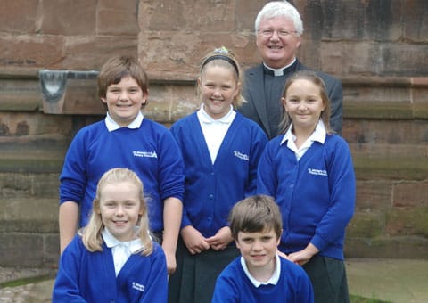 The Very Revd Adrian Dorber with pupils from St Michael’s Church of England Primary School