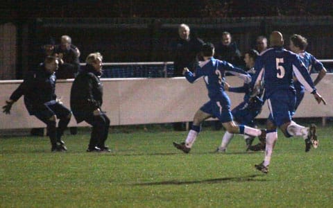 Chasetown's staff and players celebrate Dean Perrow's late winner at Mickleover Sports. Pic: Dave Birt