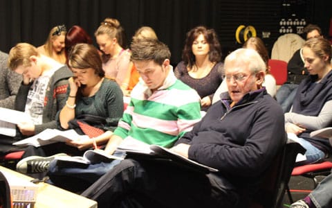 The cast of A Christmas Carol reading through the script