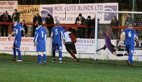 Chasetown goalkeeper Ryan Price can't stop an Ashton United free-kick finding the net. Pic: Dave Birt