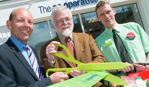 Martyn Cheatle, Cllr Ed Sharkey and store manager Tony Wills cutting the ribbon
