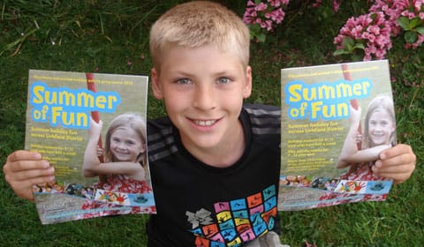 Hayden Smith with the Summer of Fun brochure