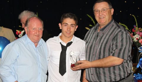 wayne_jones_and_brian_baker_present_chad_degville_with_the_young_player_ofthe_year_trophy