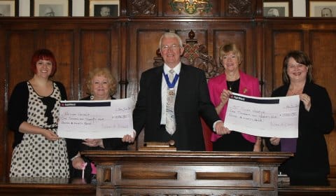 Cllr Bernard Derrick hands over the cheques