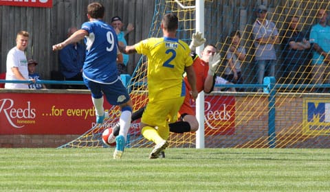 Nick Wellecomme sees his shot blocked by the King's Lynn keeper. Pic: Dave Birt