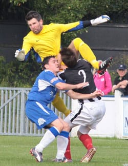 Danny Smith feels the force of a challenge from the Coalville keeper. Pic: Dave Birt Danny Smith feels the force of a challenge from the Coalville keeper. Pic: Dave Birt
