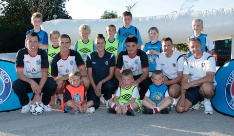 Jordan Henderson, Ben Marshall and Adam Smith with youngsters in Lichfield