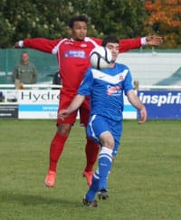 Liam Holt holds up the ball for Lichfield City