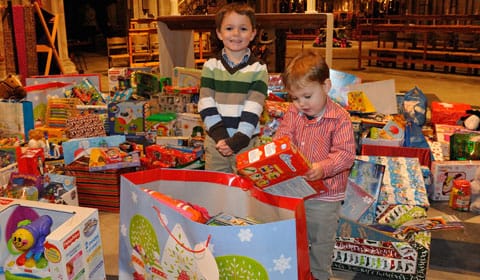 StNicholas1 Ben and Harry Lamplugh check out some of the toys collected during the 2011 St Nicholas Service. Pic: Lichfield Camera Club