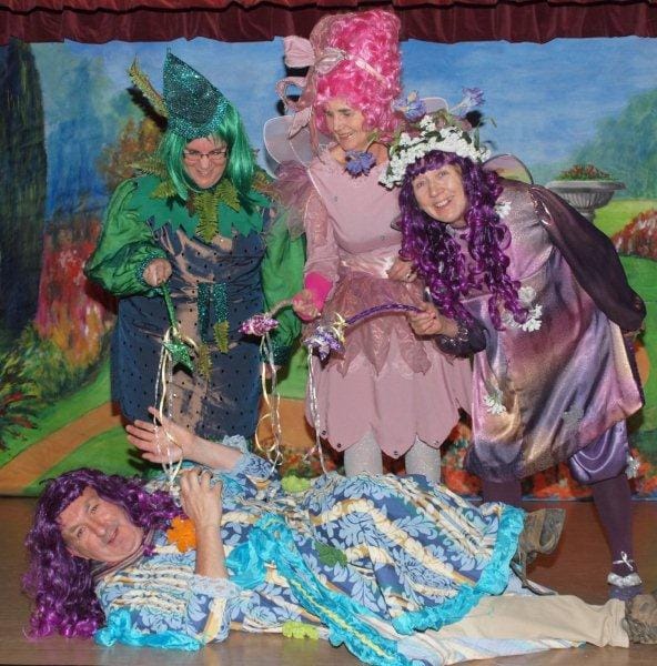 Fairies April Boyd, Barbara Stonehouse and Marilyn Melvin standing over the Dame played by Dave Daly. Pic: John Richardson