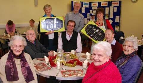 Simon Price hands over cutlery sets to Churches Together Christmas Day Lunch volunteers