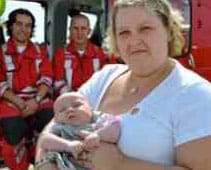Helen Turner with her daughter and the Midlands Air Ambulance flight crew