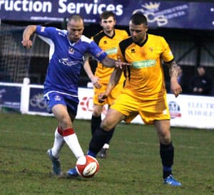 Gary Hay tries to escape the attentions of a Leek Town player. Pic: Dave Birt