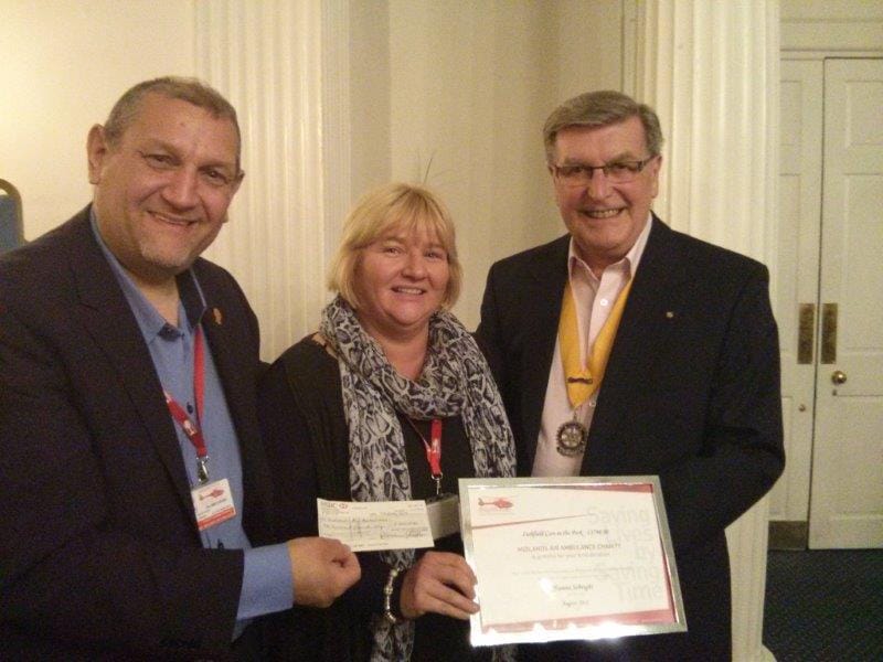 The cheque is handed over to the Midlands Air Ambulance team