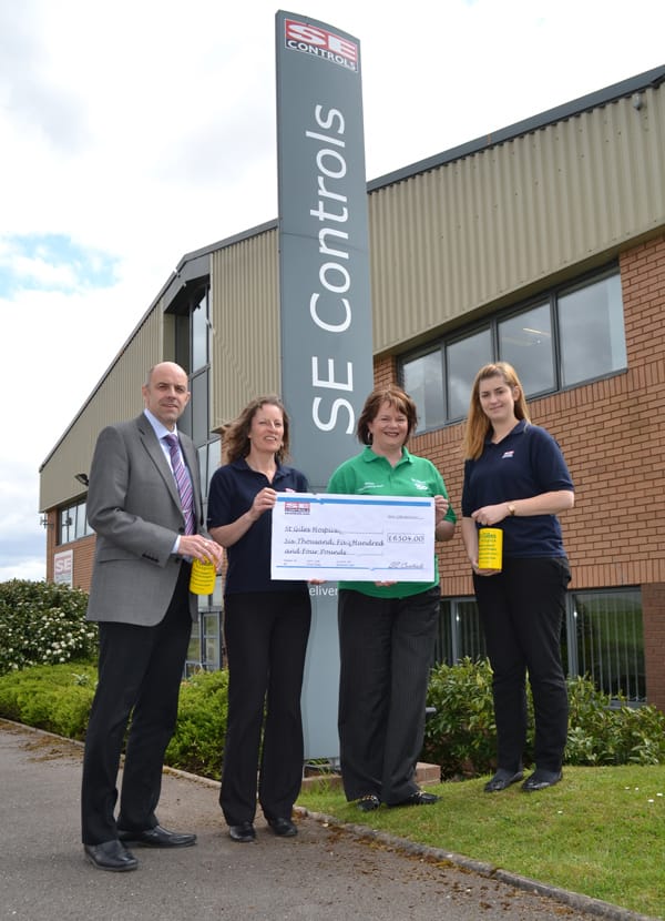 Staff from SE Controls present a cheque to Helen Relihan from St Giles Hospice