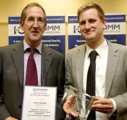 Peter Lawrence presents Andrew Nicholls with his award