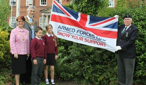 Students Piotr Zieba and Katie Edwards join Jan Leytham, Cllr David Leytham and Cllr Bernard Derrick to raise the Armed Forces Day flag
