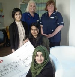 Nazish Begum (centre) hands over the cheque to midwife Sam Collins and delivery suite manager Helen Hurst with help from her friends Sabba Chaudhry and Rahema Liaqat