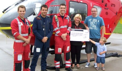 Tom Waters (Paramedic), James Benson (Pilot), Rob Till (Paramedic) and Jo Bailey  receive the cheque from Garry Mitchell and Callum