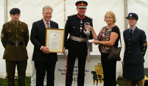 The Lord-Lieutenant Ian Dudson CBE,  Jane Dudson, James Whittaker and Christine Gilbert accepting the award and certificate on behalf of the museum volunteers, with two cadets from the Lieutenant's office