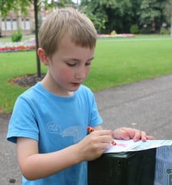 A youngster tries out the brass rubbing trail