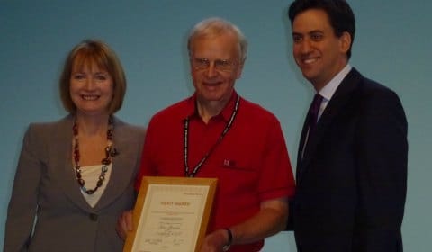 Cllr John Brooks receives his award from Harriet Harman and Ed Miliband