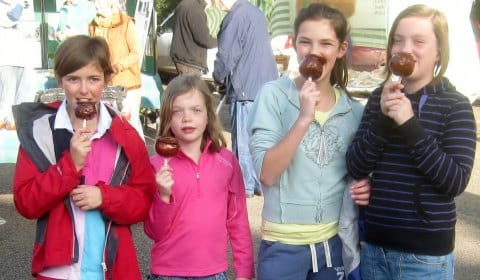 Youngsters enjoying toffee apples at Whittington's regular Apple Day event