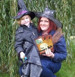 Park ranger Stacey Coleman gets ready for the Halloween trail with a young visitor