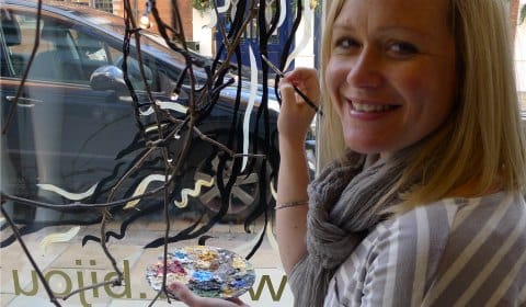 Fay Shoesmith working on one of her window murals