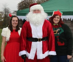 Elves Katy Humpage and Stacey Coleman with Santa
