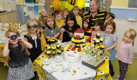 Children at the Busy Bees nursery in Burntwood celebrating with co-founders Marg Randles and John Woodward