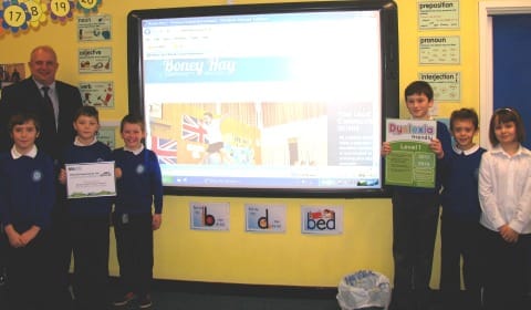 Staff and students at Boney Hay Community Primary School with their new interactive whiteboard