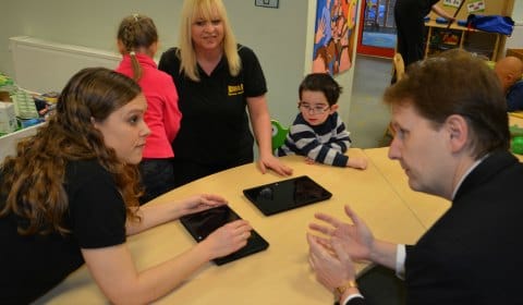 Beth Styles and Sue Dooley discussing the new tablet computers with Matthew Ellis