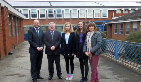 Assistant headteacher Oliver Forster and Henry Exton with Friary School students Alice Arnstein and Emily Townsend, and Kate Sadler from Southern Staffordshire Community Energy in front of the new solar panels
