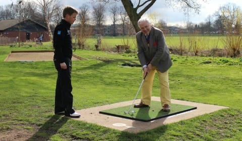 Cllr David Smith gets some advice on his swing