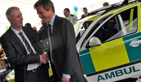 Paul Dadge with Hugh Grant and the new car. Pic: West Midlands Ambulance Service